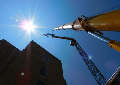Crane & Hoist Equipment SA's service team removing the final counter weight block during the dismantling of a Potain MDT178 tower crane.