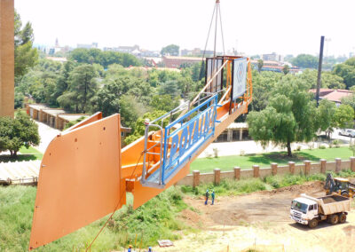 The counter jib of a Potain MDT 178 tower crane being lowered during a dismantling.